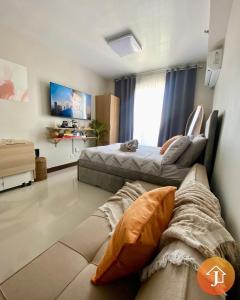 a living room with two beds and a couch at Studio With Balcony Near Beaches in Mactan in Lapu Lapu City
