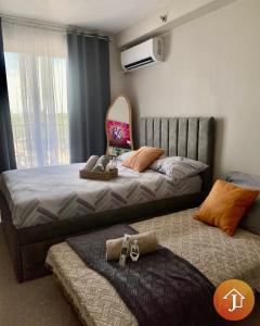 a bedroom with a bed with a surfboard on it at Studio With Balcony Near Beaches in Mactan in Lapu Lapu City