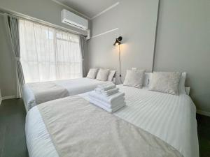 Cama o camas de una habitación en Neighbor's Hotel 西十日市