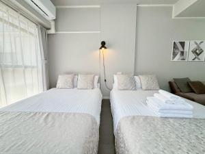 Cama o camas de una habitación en Neighbor's Hotel 西十日市