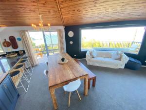 a living room with a table and a couch at Viewpoint 8 in Karikari Peninsula