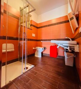 a bathroom with a toilet and a glass shower at Ciuscia in Calatabiano +32 photos