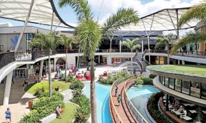 an image of a shopping mall with palm trees at Star above, Ocean Beyond - Lv 43 Luxury Apartment with Panoramic View on The Star Casino Broadbeach in Gold Coast