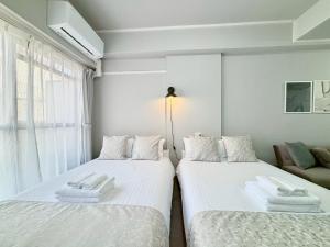 Cama o camas de una habitación en Neighbor's Hotel 西十日市