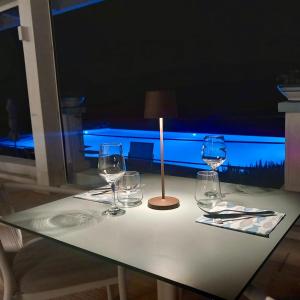 a table with wine glasses and a candle on it at Casamediterranea in Sperlonga
