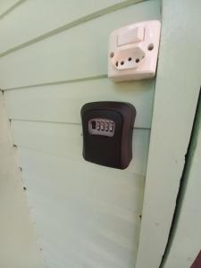 a remote control on the wall of a house at Cabana Caminho de Pedras in Montenegro
