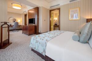 Postel nebo postele na pokoji v ubytování Wuhan Jin Jiang International Hotel