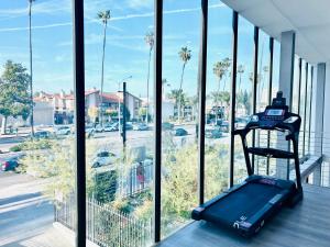 a suitcase sitting on a table in front of a window at New Lux Skyline Loft in LA in North Sherman Way