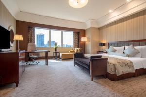 Postel nebo postele na pokoji v ubytování Wuhan Jin Jiang International Hotel