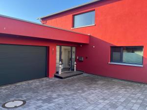 a red building with a garage at Luna Apartment in Dinkelsbühl