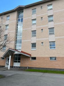 a large brick building with a lot of windows at Annela, kodikas kaksio Euran sydämessä in Eura +2 photos