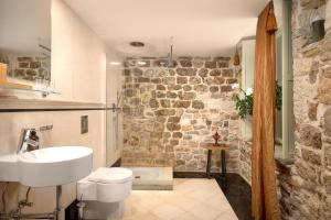 a bathroom with a white toilet and a sink at Palazo dei CONTI in Split Centre OLD town in Split +25 photos