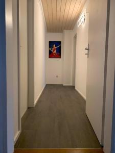 a hallway of an art gallery with a painting on the wall at Bockhorn Farmhouse in Bockhorn