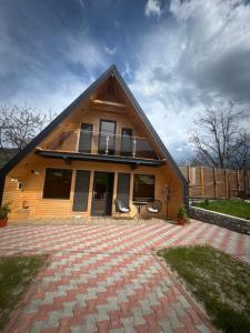 a large house with a large patio in front of it at LKS A-frame in Corbi