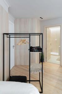 a bedroom with a black rack with shoes and a mirror at Apartamentos Ca Gracia 2 adaptado in Bocairent