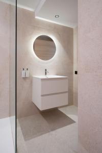 a bathroom with a white sink and a mirror at Apartamentos Ca Gracia 2 adaptado in Bocairent