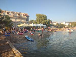 a group of people on a beach near the water at Mare Blue in Pirovac