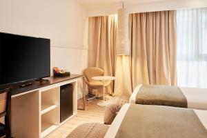 Телевизор и/или развлекательный центр в Esplendor by Wyndham Savoy Rosario
