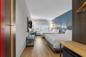 a hotel room with two beds and a desk at Tru By Hilton Cape Girardeau in Cape Girardeau +36 photos