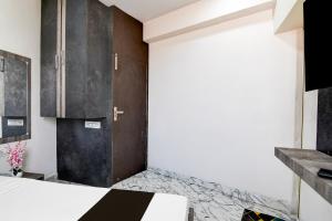 a bedroom with a bed and a cabinet at Hotel O S. R. ROYALE in Kolkata +36 photos