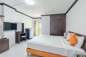 a bedroom with a large bed and a television at One Residence Navanakorn in Pathum Thani +11 photos