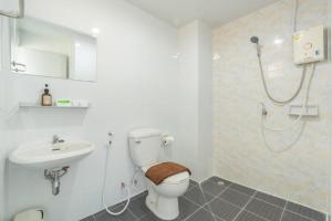 a bathroom with a toilet and a sink and a shower at One Residence Navanakorn in Pathum Thani +20 photos