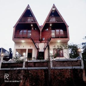 a large house with large windows and balconies on it at The Aisyah Cabin in Wonosobo