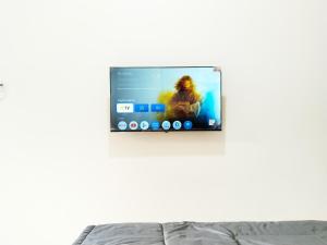a flat screen tv hanging on a wall at Roemah Kavaleri powered by Cocotel in Bandung