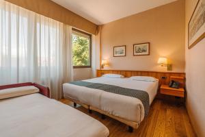 Postel nebo postele na pokoji v ubytování Crystal Hotel Varese