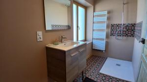 a bathroom with a sink and a window at Maison Locquirecoise à 550m de la plage in Locquirec