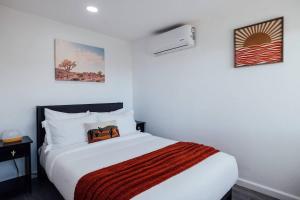a bedroom with a large white bed in a room at Modern Sunset in Yucca Valley +37 photos