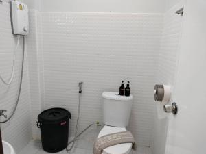 a bathroom with a toilet with bottles on top of it at อามา ภูลังกา เฮาส์ in Ban Sakoen