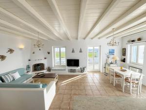 a living room with a couch and a table at Sunny House in Pounda