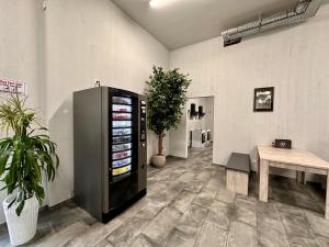 an empty room with a black refrigerator and a table at GPHotel/Boardinghaus in Leverkusen