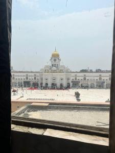 a large white building with a clock tower at Arora guest house in Amritsar