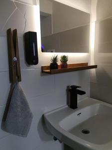 a bathroom with a sink and a mirror at La Casita de Cullera in Cullera +47 photos