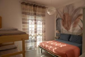 a bedroom with a bed and a window at Residence Valeria in Cervia