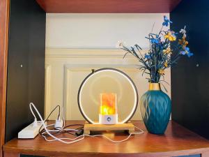 a table with a mirror and a vase with flowers at Seaview unit in Manila +14 photos