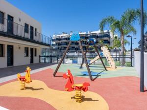 a playground with a play equipment in a resort at Winahost Apartment Neo Residencial Mediterráneo in Barrio-Mar