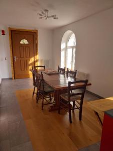 a dining room with a wooden table and chairs at La Casa nel Bosco BeB in Bee