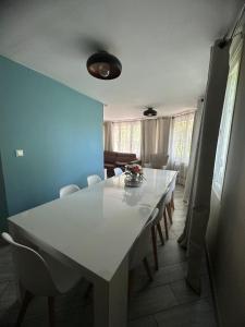 a white table and chairs in a dining room at Ancienne Maison de Campagne in Grans