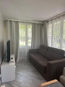 a living room with a couch and a television at Ancienne Maison de Campagne in Grans +18 photos