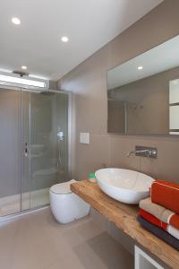 a bathroom with a sink and a toilet and a shower at Villa Ghislena by salentoltremare in Marina San Gregorio