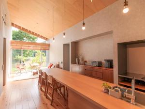 a kitchen with a long bar with a television in it at 宿龍宮 in Tatsugo