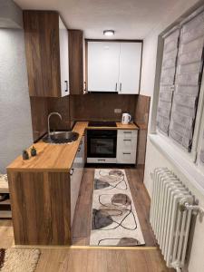 a small kitchen with a sink and a microwave at A&A Apartment in Sarajevo +36 photos