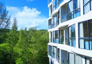 an apartment building with a view of the mountains at Laya Suites and Residences in Bang Tao Beach +51 photos