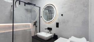 a bathroom with a sink and a mirror at GOLD APARTMENTS Panorama Kwiatkowskiego in Rzeszów +25 photos