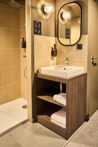 a bathroom with a sink and a mirror at JOST Auberge de Jeunesse Lille Centre in Lille +73 photos
