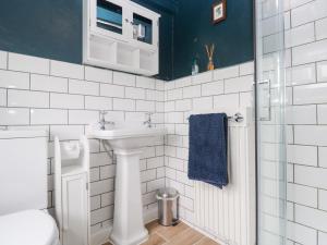 a white bathroom with a sink and a toilet at Pentira in Helston +40 photos