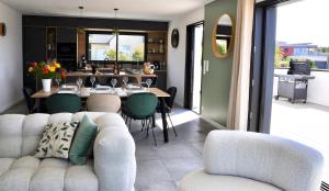 a living room with a couch and a table at Villa Au Rythme Des Marées in Carantec +42 photos